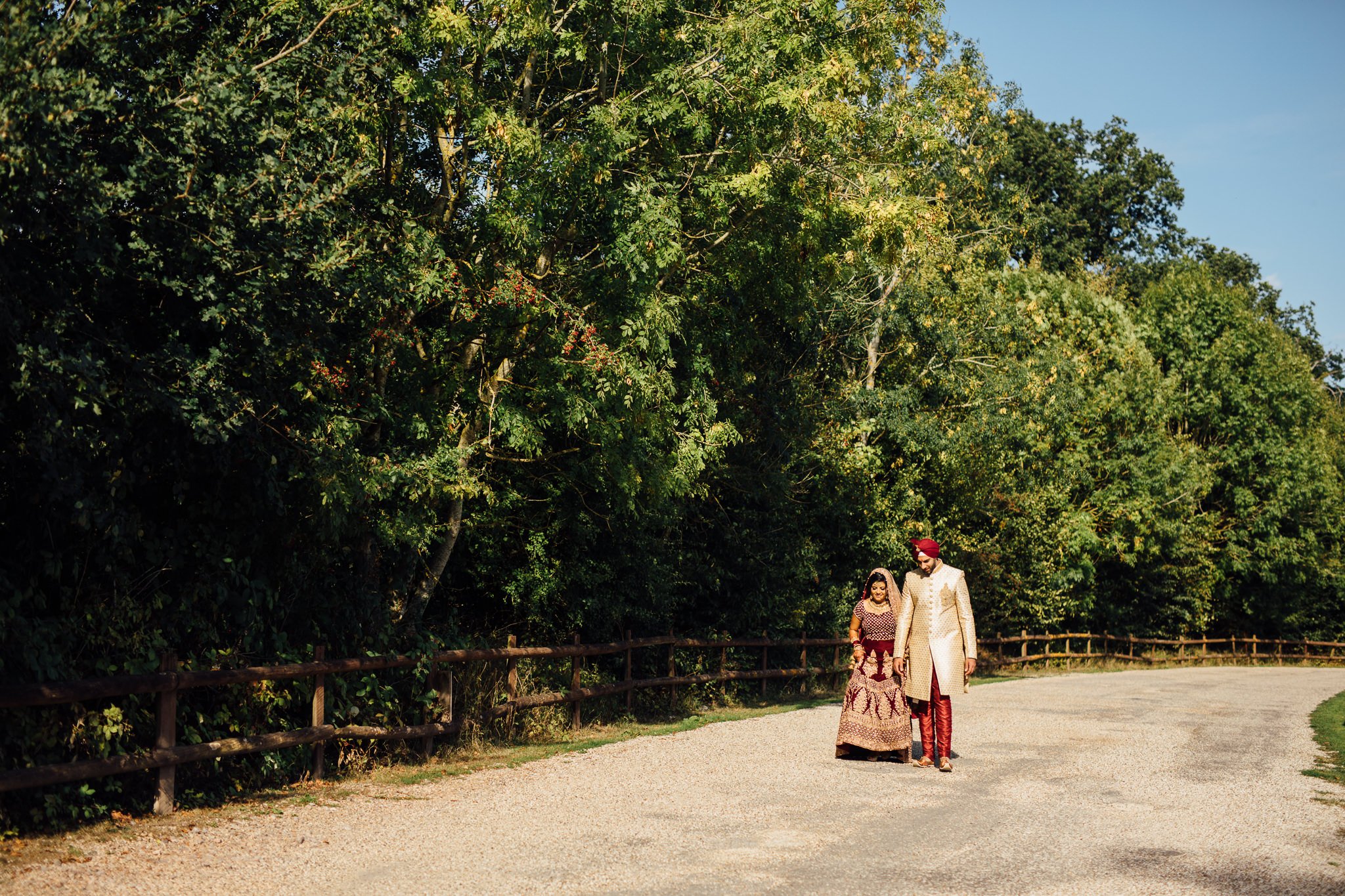  Bride and Groom walking down a lane at Trunkwell House in Berkshire 