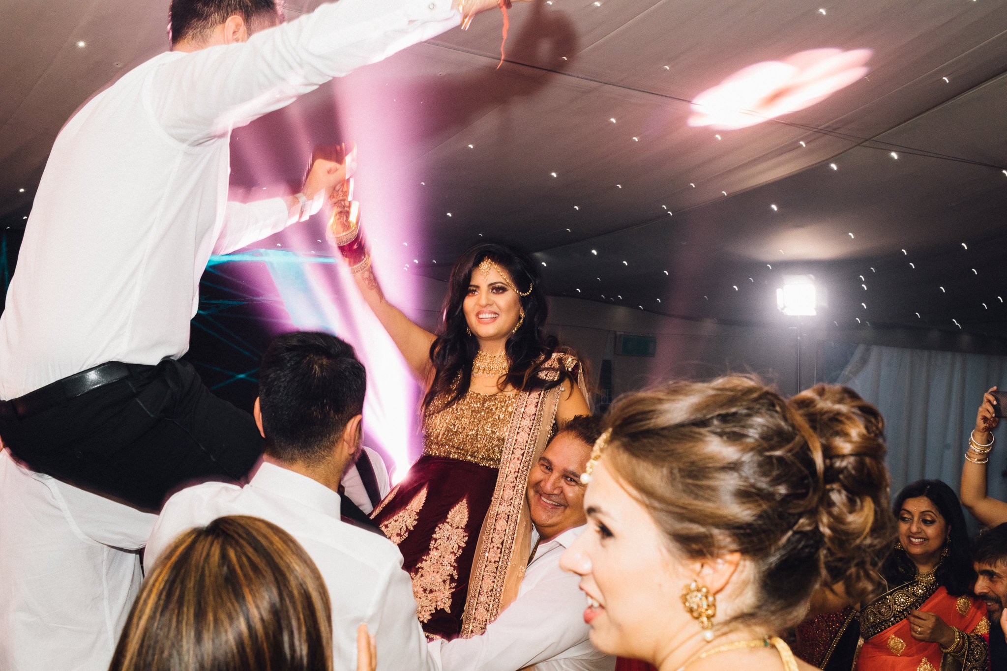  Bride and Groom being held aloft on the dance floor at Trunkwell House in Berkshire 