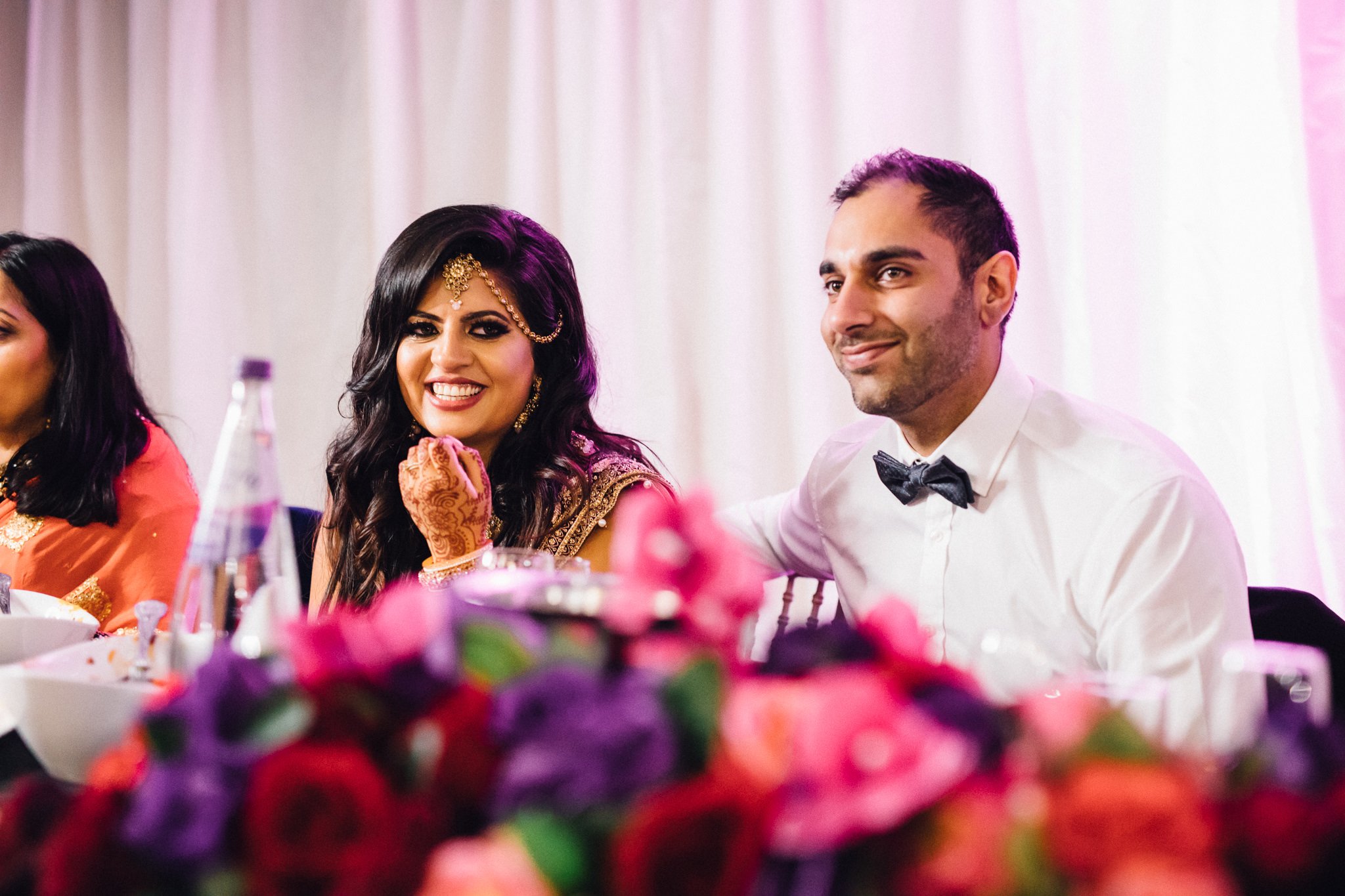  Bride and Groom smiling during the speeches at Trunkwell House in Berkshire 