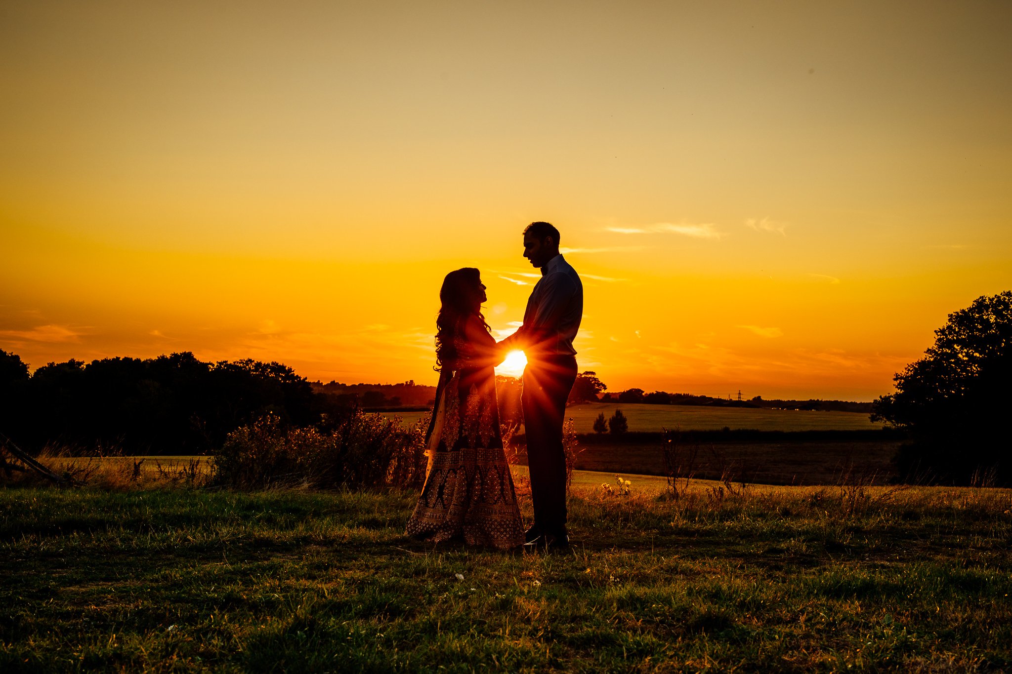  Silhouette of Bride and Groom as the sun sets at Trunkwell House in Berkshire 