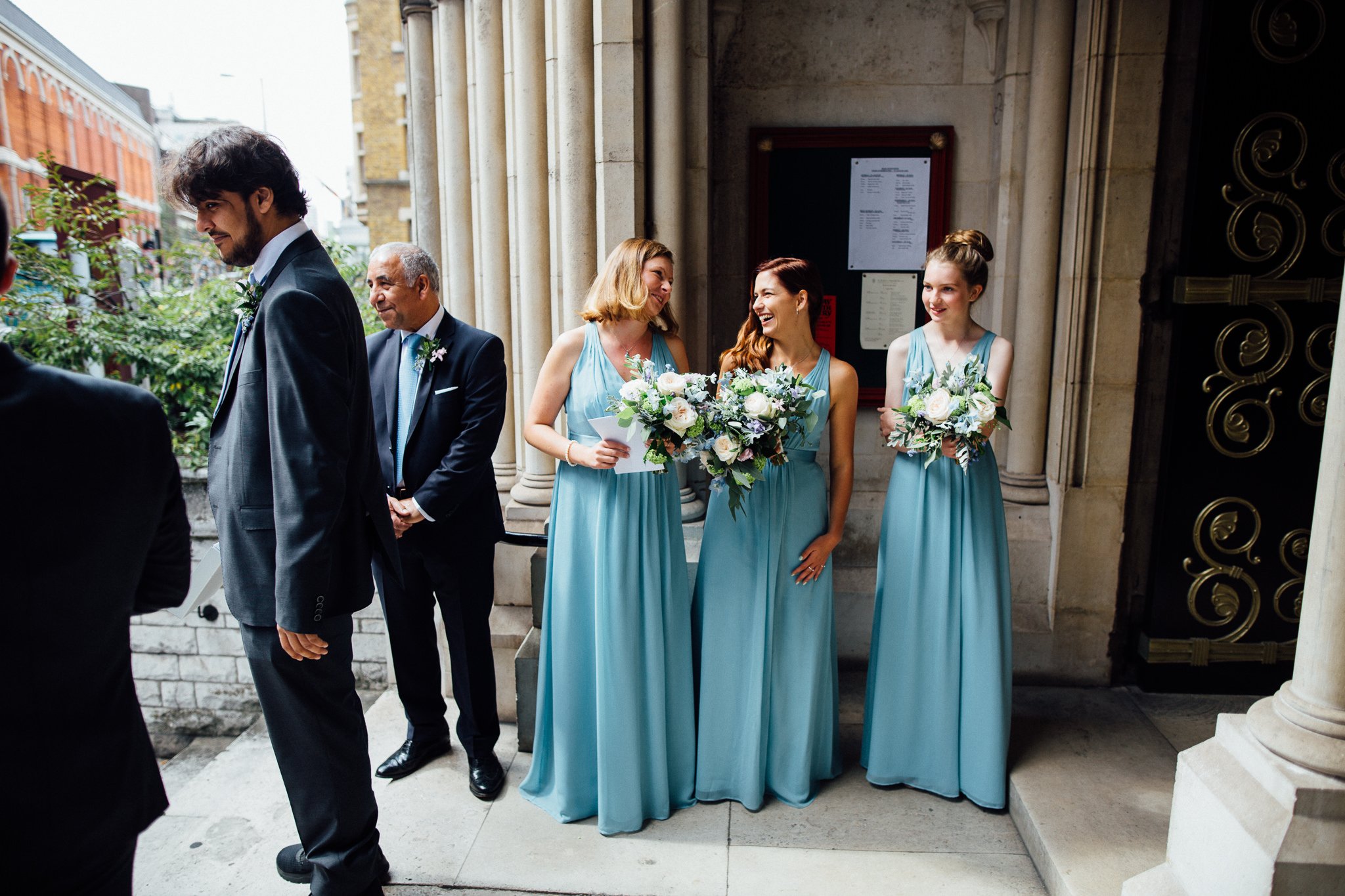  Bridemaids laughing outside St James Church, Spanish Place Marlyborne 