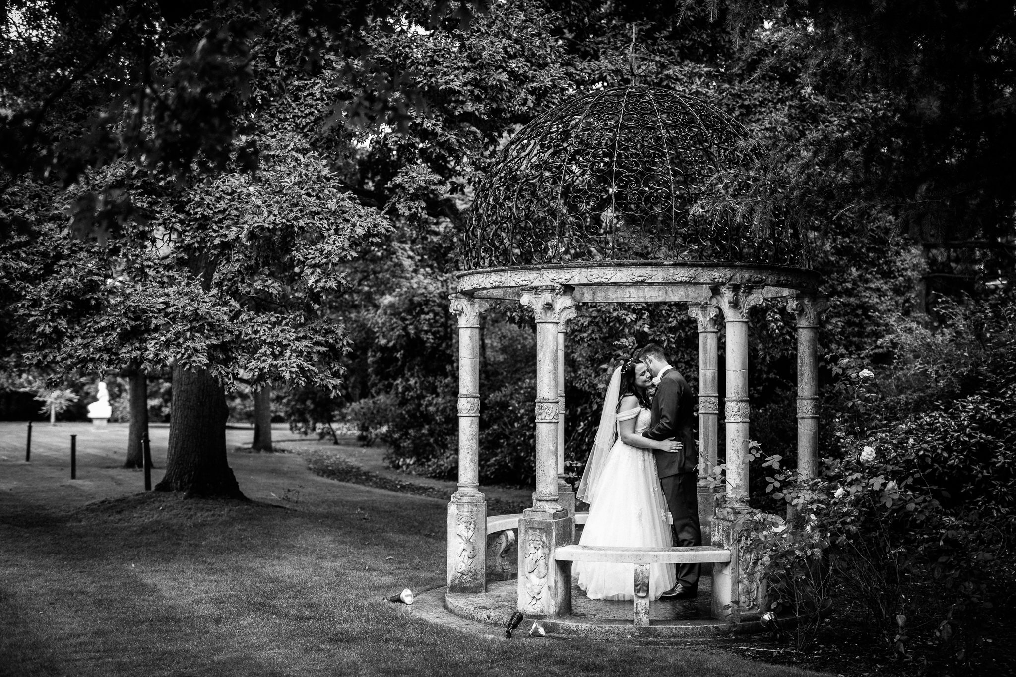  Bride and Groom hug on the grounds of Warren House Hotel Kingston upon Thames 