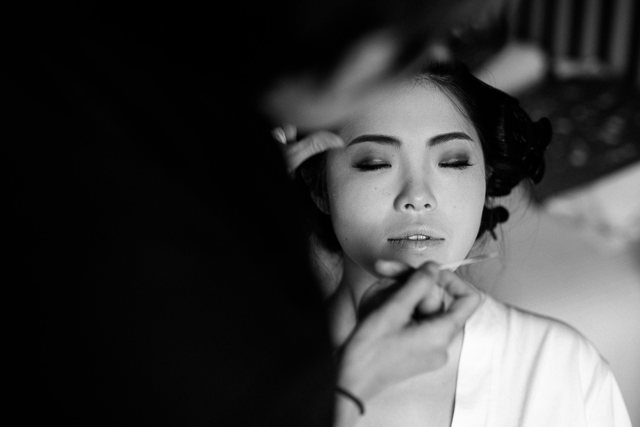  Bride having makeup applied on her wedding day 