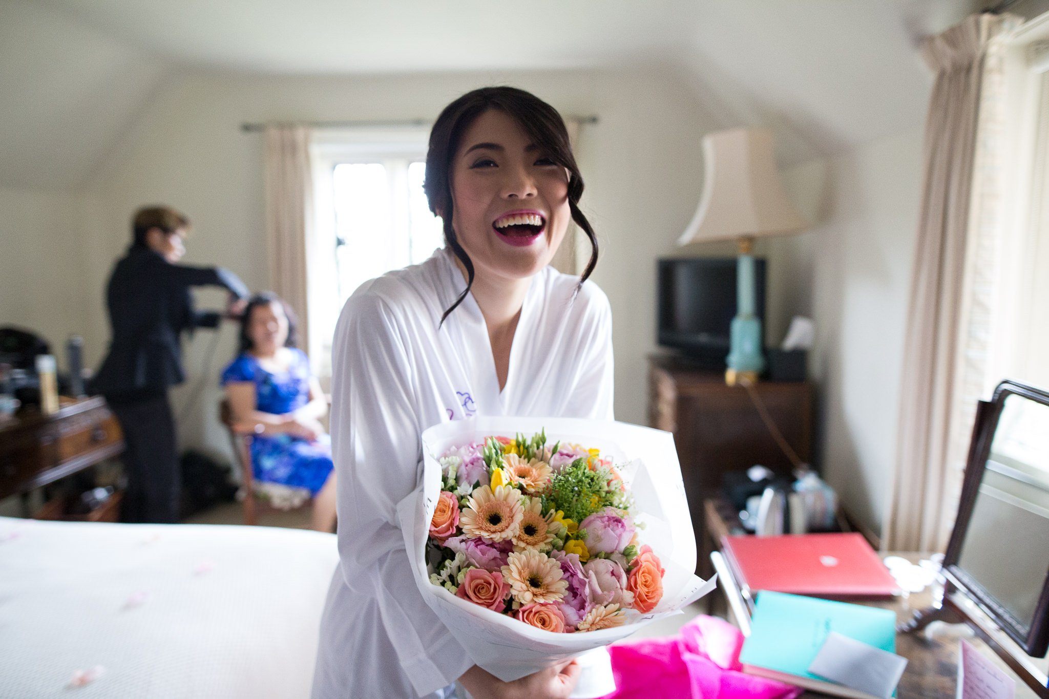  Bride smiling with bouquet of flowers 