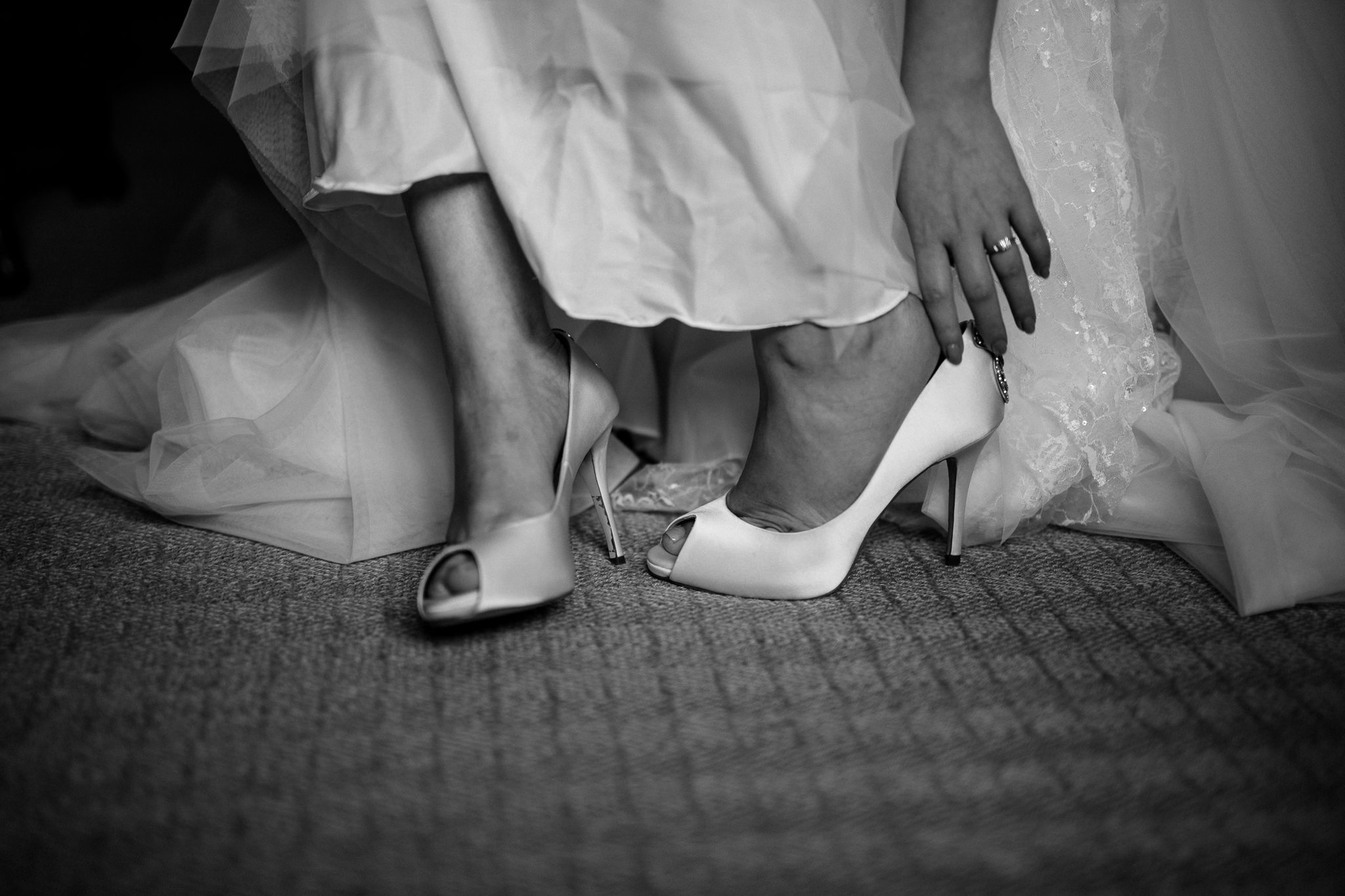  Bride puts her wedding shoes on at Great Fosters Egham 