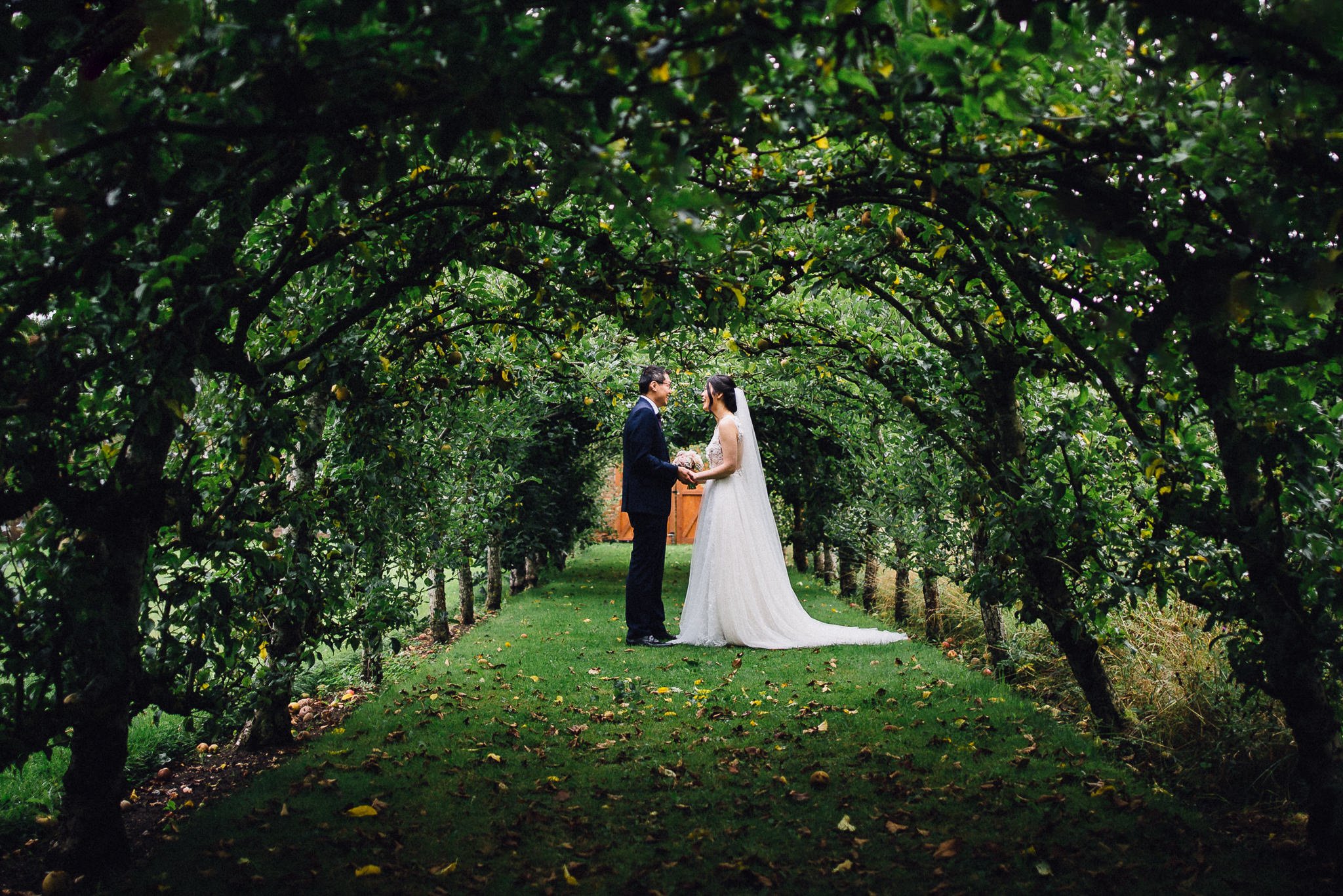  Bride and Groom in a wooded section at Great Fosters Egham 