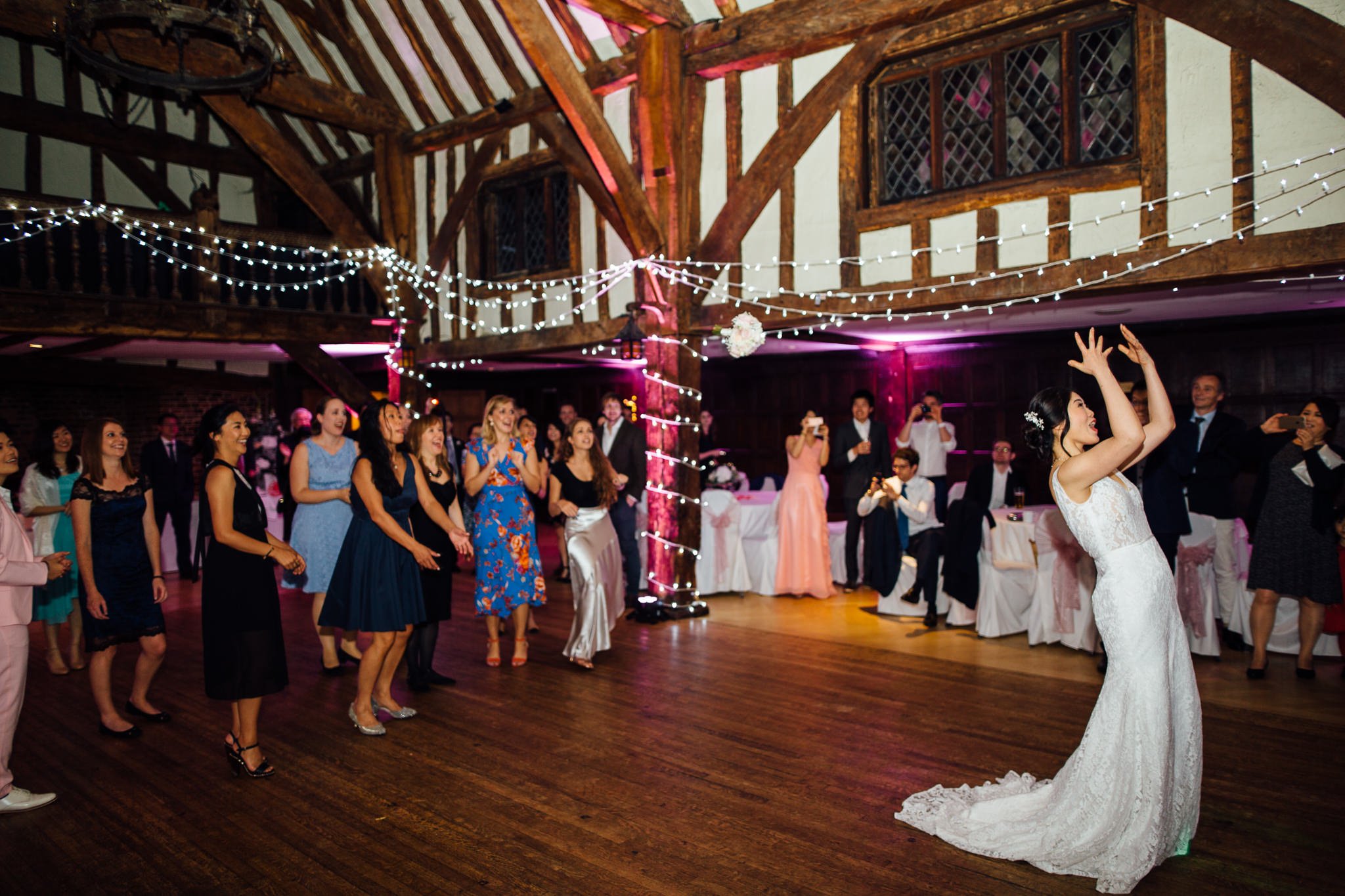  Bride throws bouquet at Great Fosters Egham 