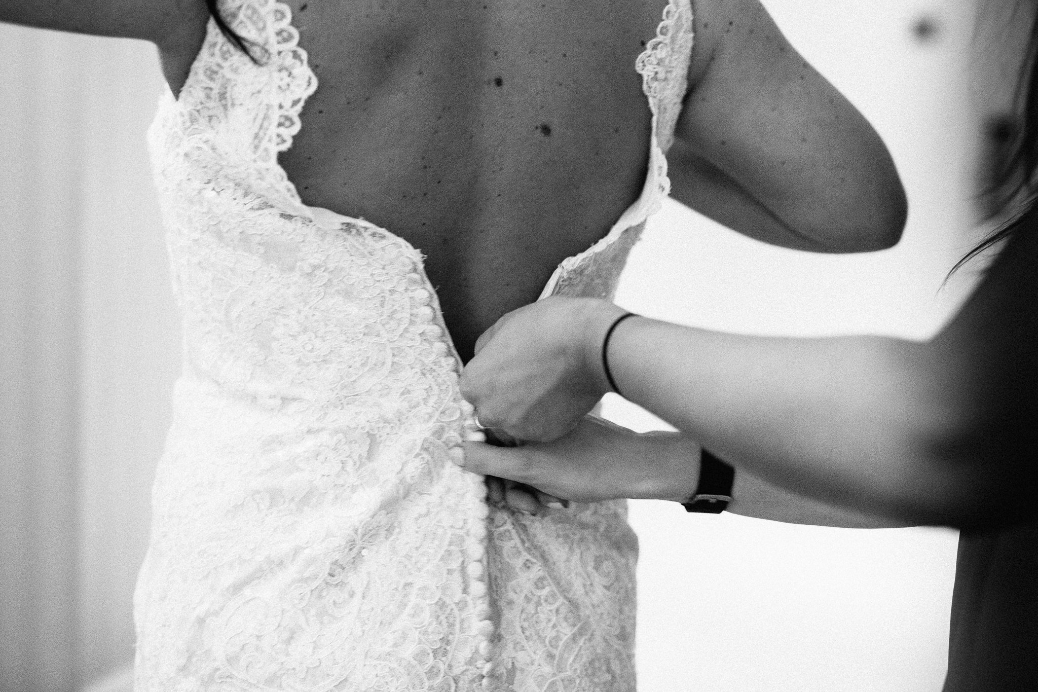  Back of wedding dress being zipped up 