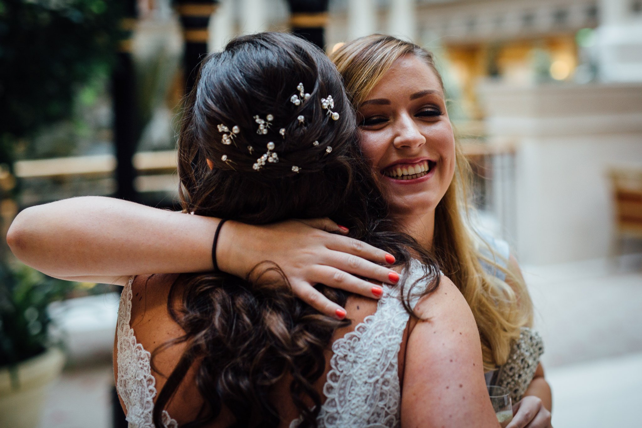  Female guest hugs the Bride 