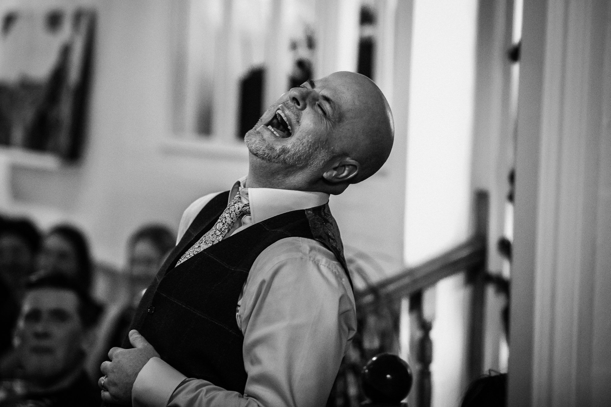  Groom laughing with his head back 