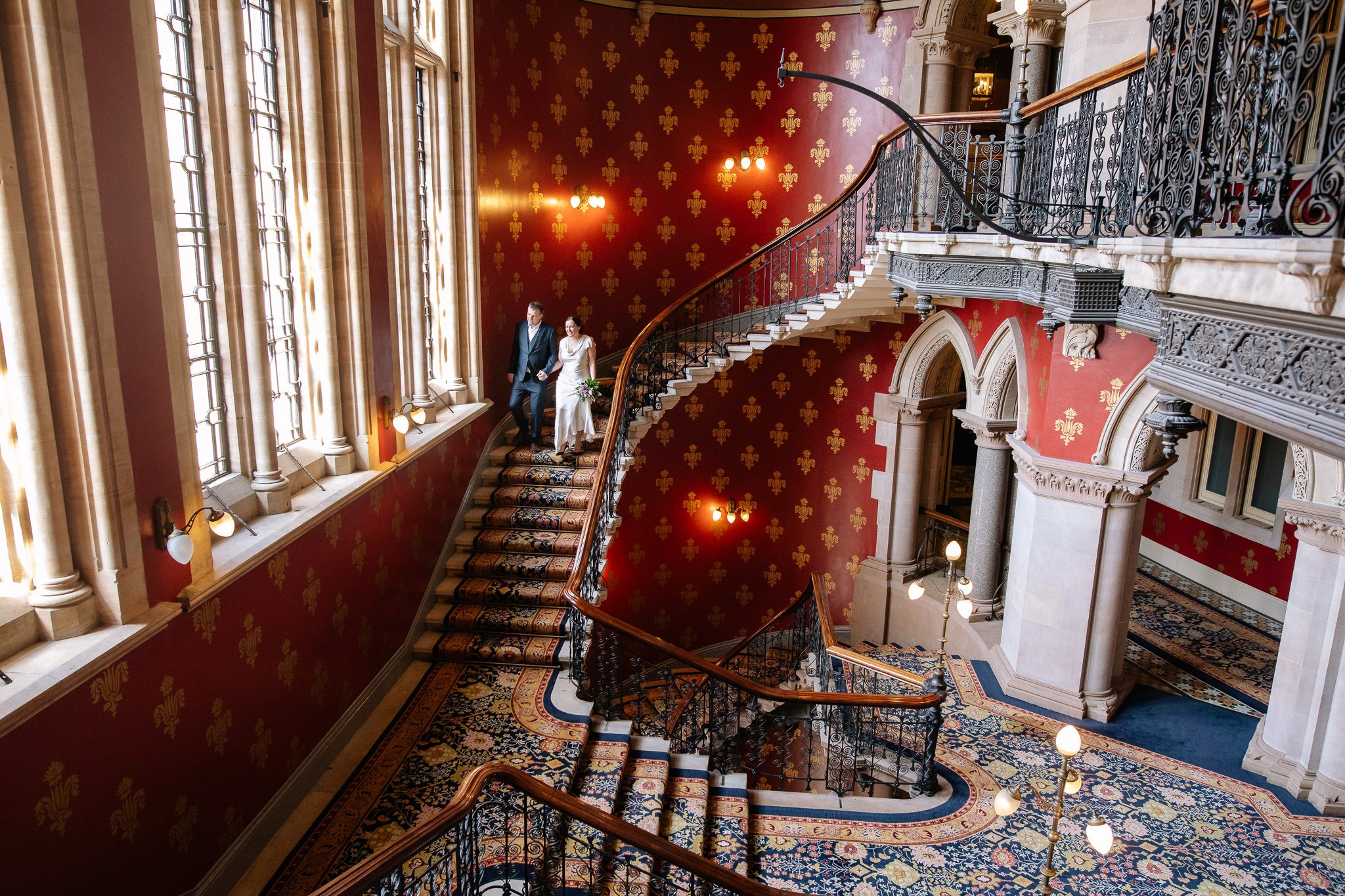  Bride and Groom descend the staircase at St. Pancras Renaissance Hotel London 