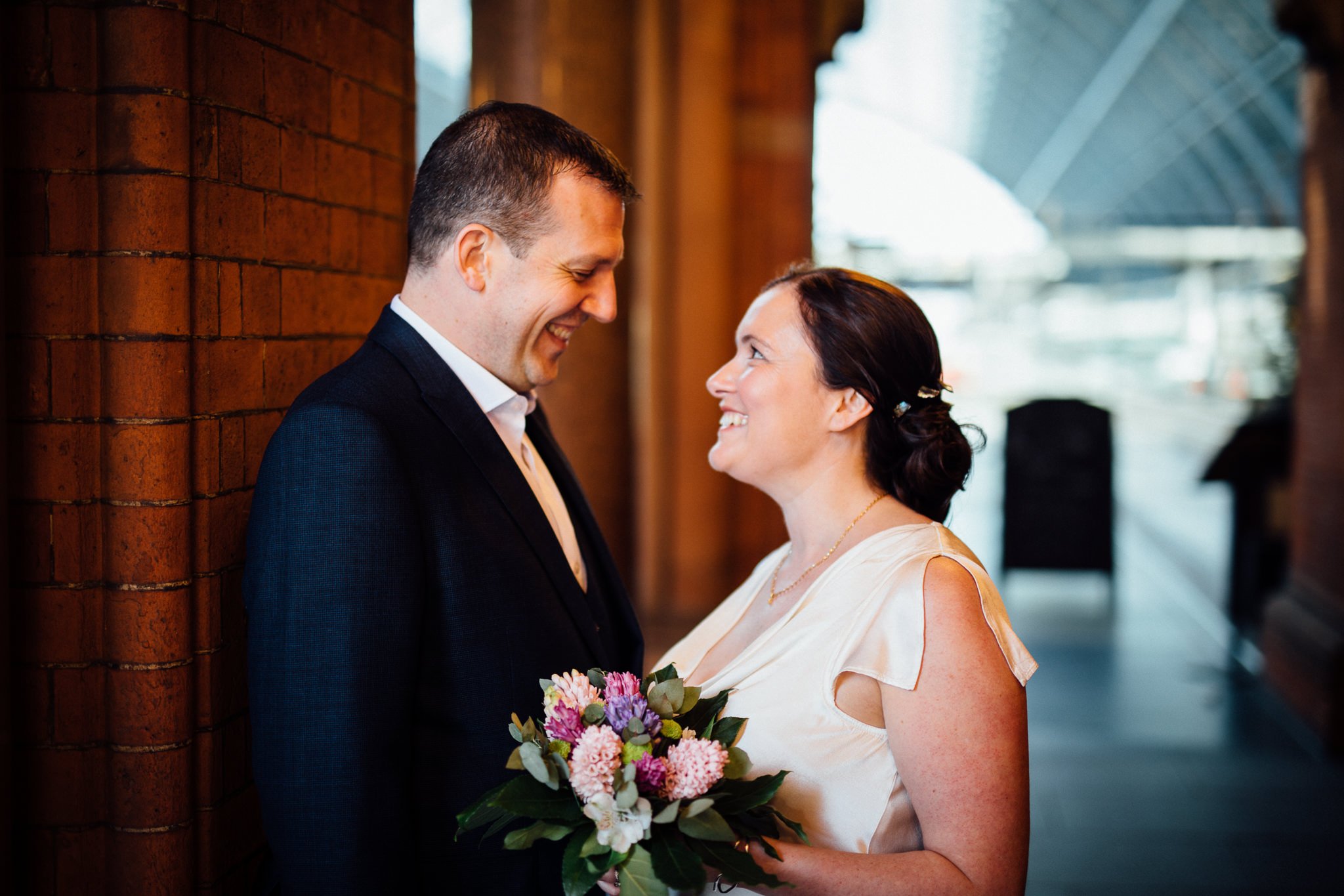  Bride and Groom smiling at each other in St Pancras  