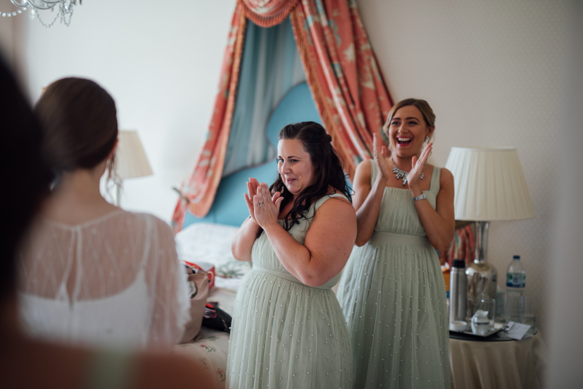  Bridesmaid are overjoyed at seeing the bride in her wedding dress for the first time 