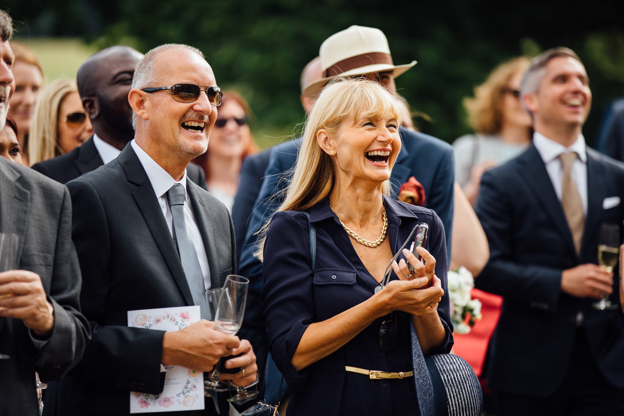  Guests laugh during the speeches at  Wadhurst castle wedding venue 