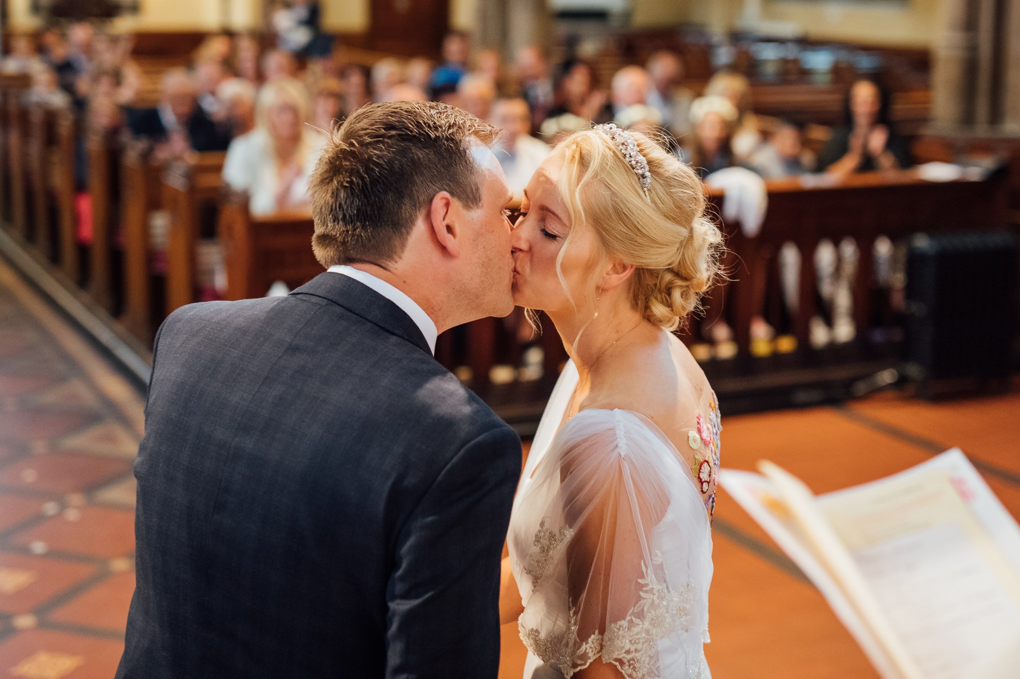  Bride and Groom kiss at All Saints Stand Church Whitefield 