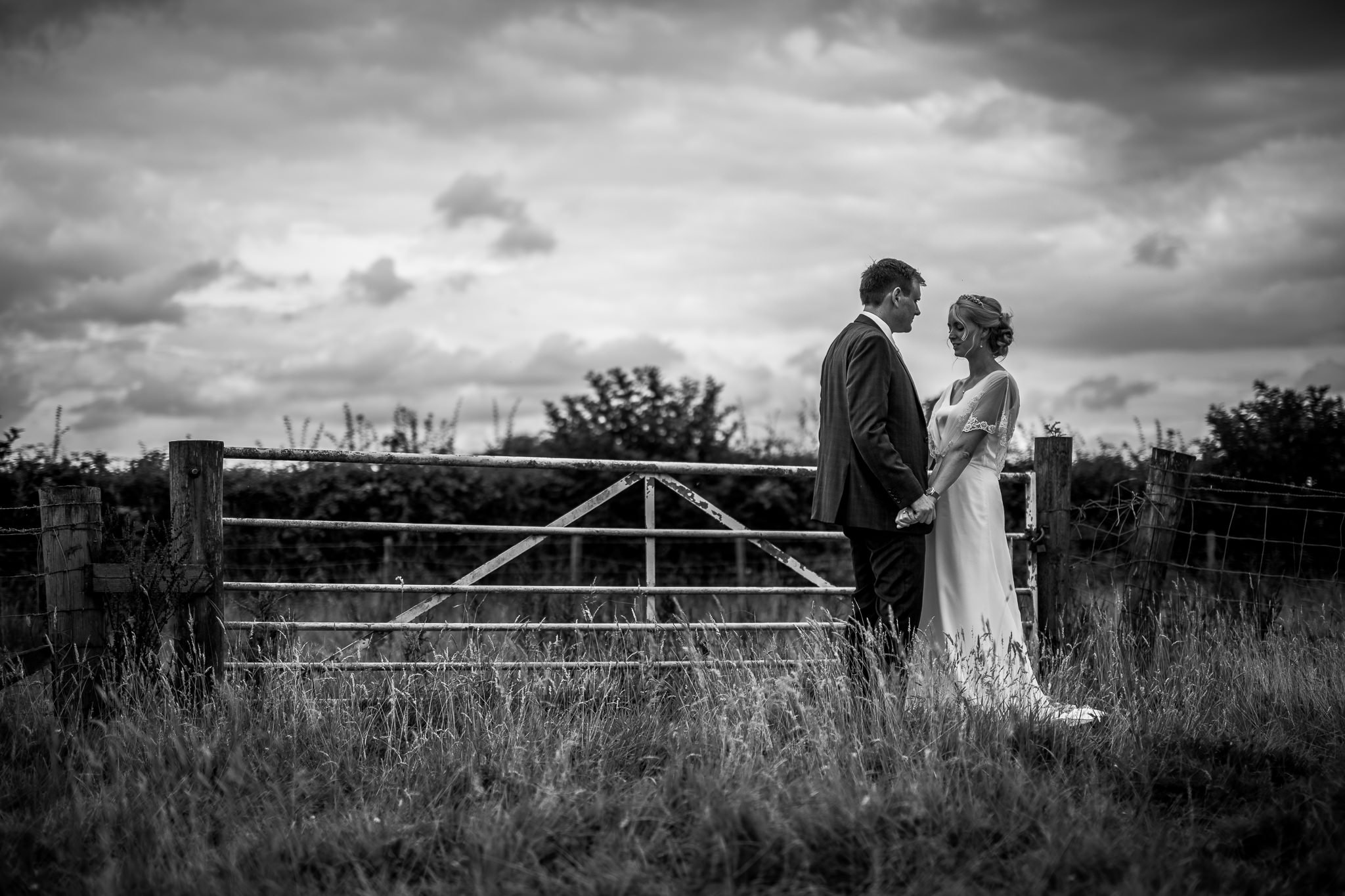 Bride and Groom in front of a gate at The Stables in Bury 