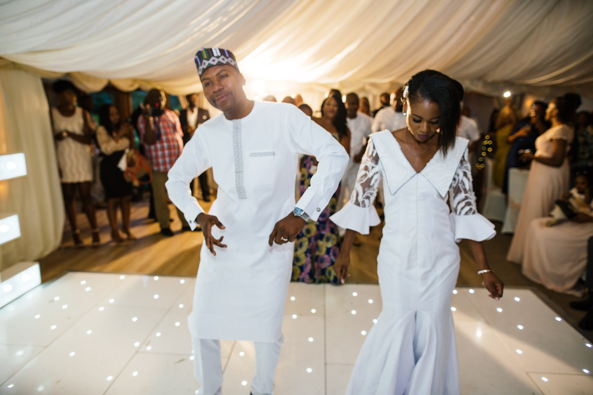  Bride and Groom dance at Newland Hall Essex wearing traditional Nigerian attire 