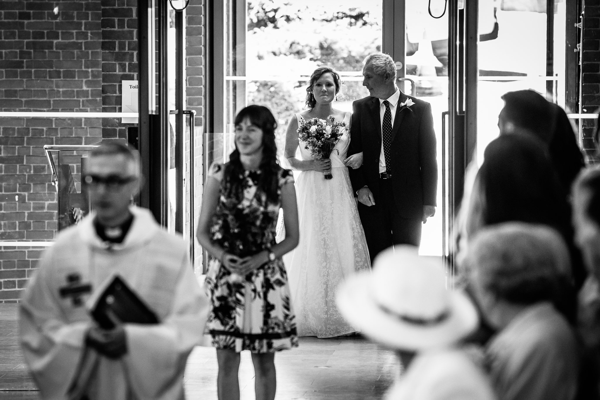  Bride walks down the aisle at Inside of All Saints West Dulwich Church 
