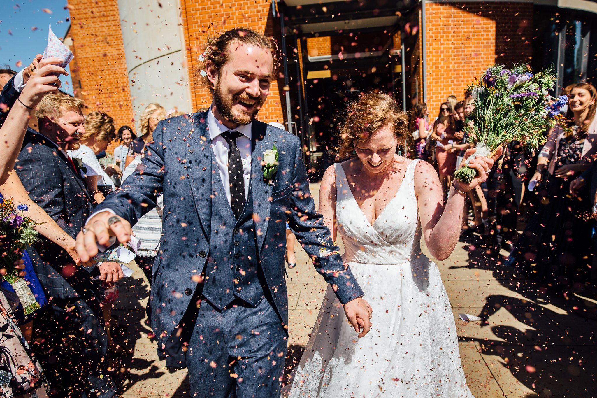  Bride and Groom have confetti thrown at them at Inside of All Saints West Dulwich Church 
