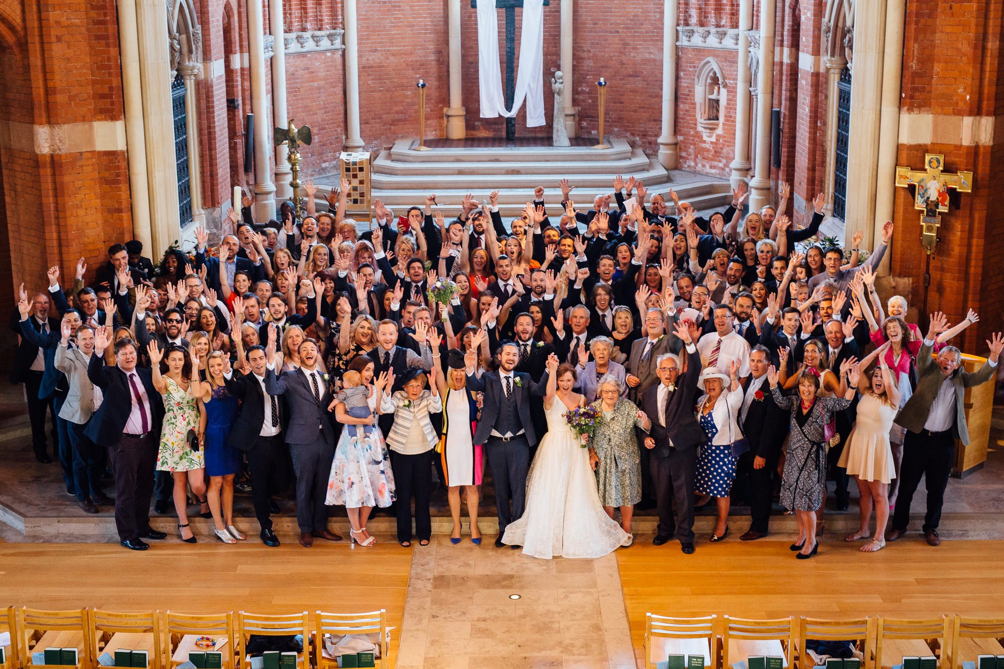  Group photo of all the wedding guests at Inside of All Saints West Dulwich Church 