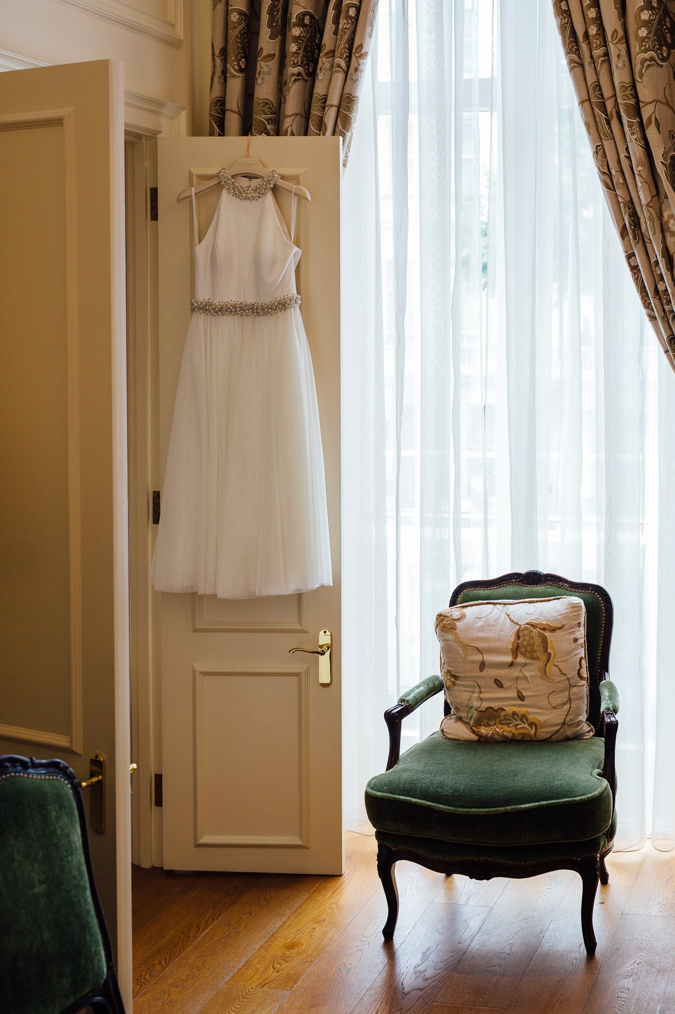  Bride’s dress hangs up at The Kensington Hotel 