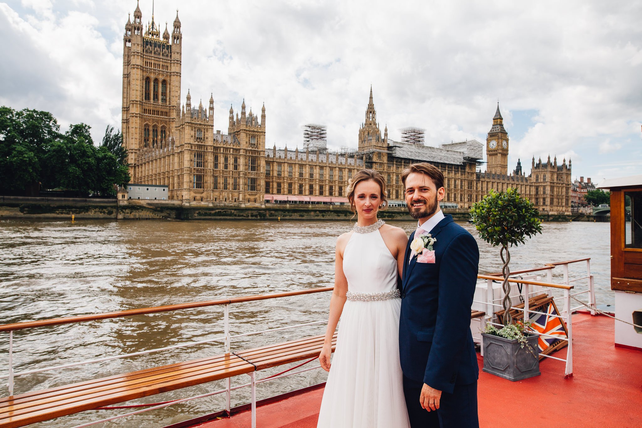  Bride and Groom on a boat on the Thames in front of the Houses of Parliament  