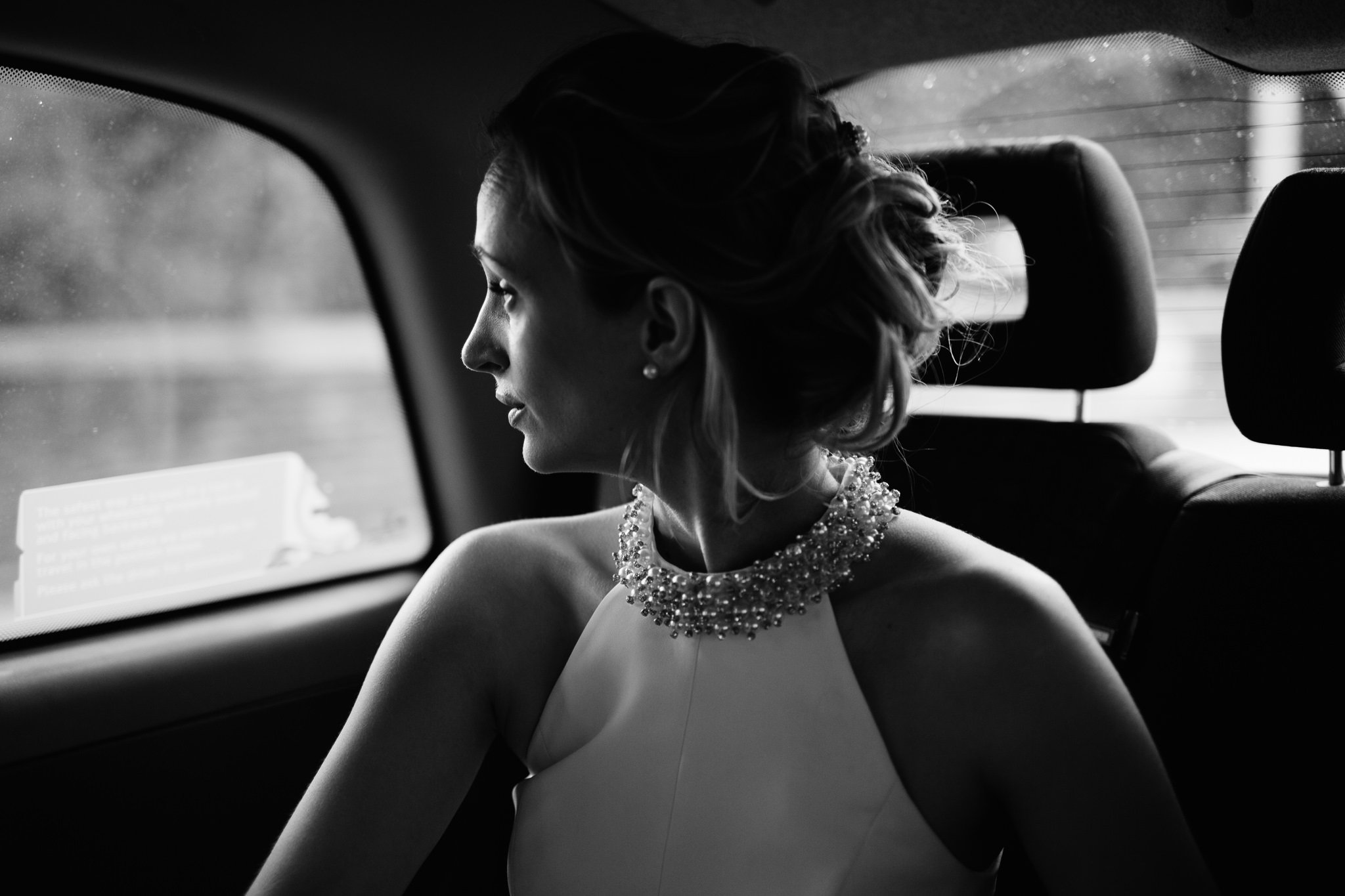  Bride looks out of the window of a black cab 