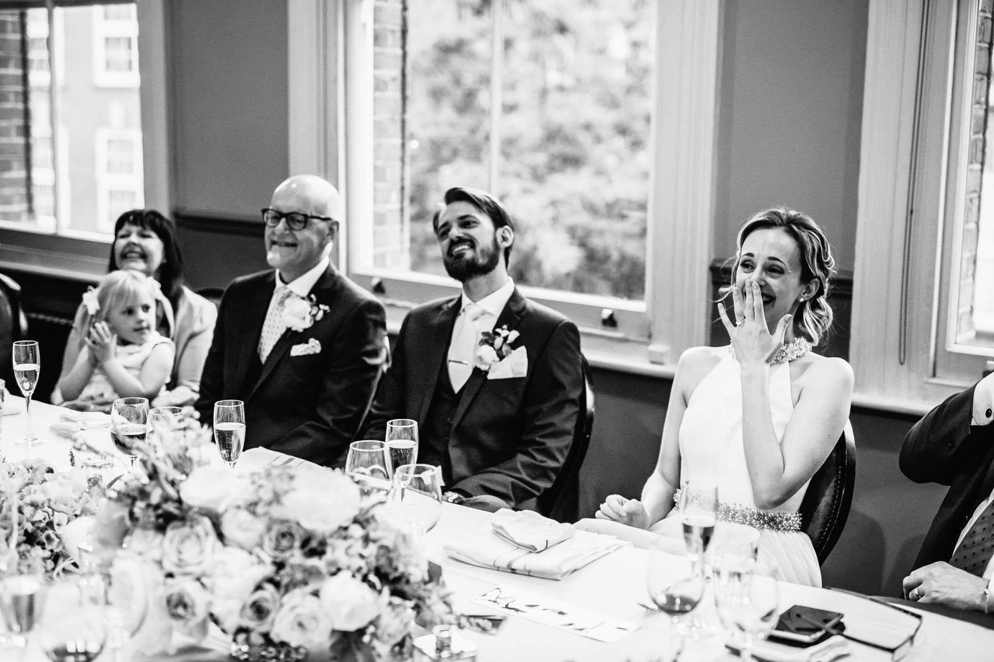  Wedding guests laugh during the speeches 