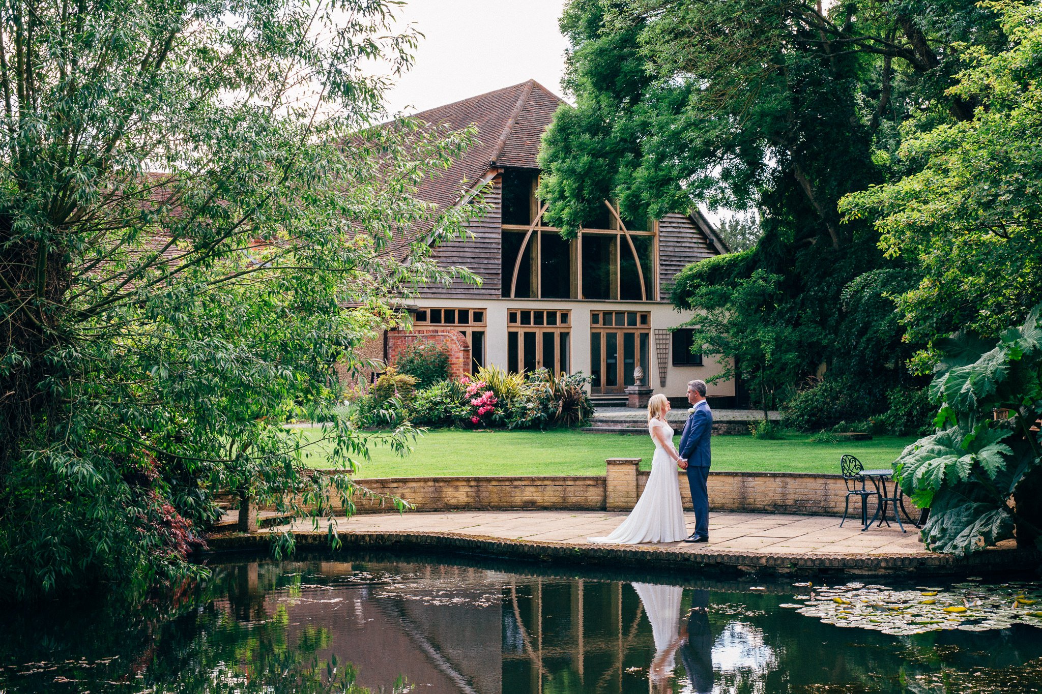  Bride and Groom standing next to the lake at Rivervale Barn 
