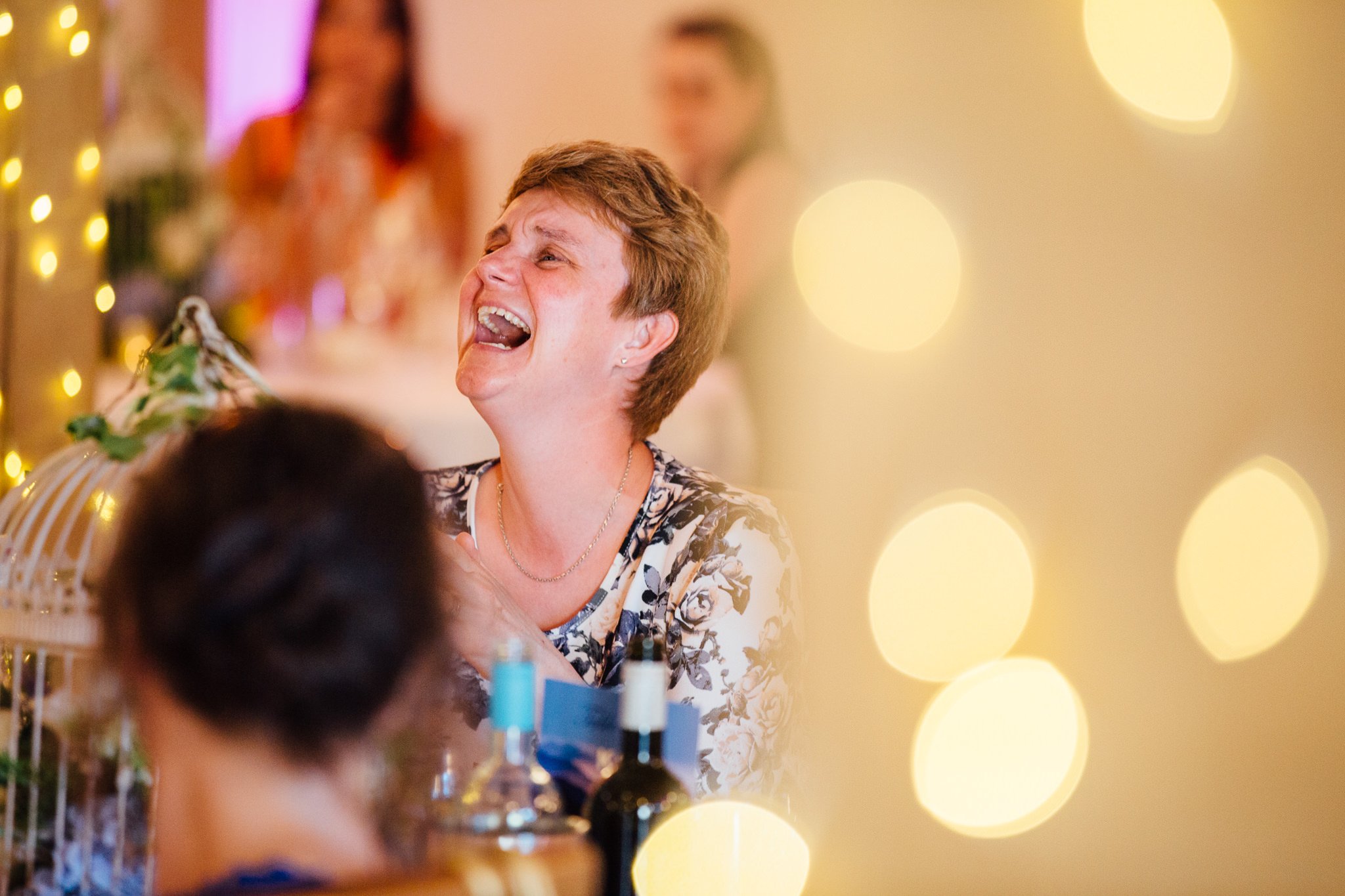  Female wedding guest laughing 