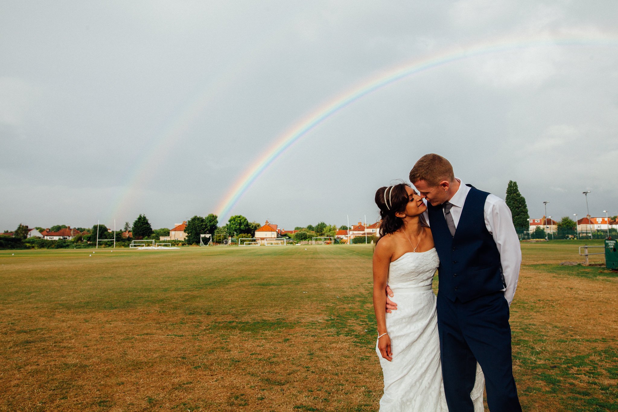  Bride and Groom kiss under a rainbow 