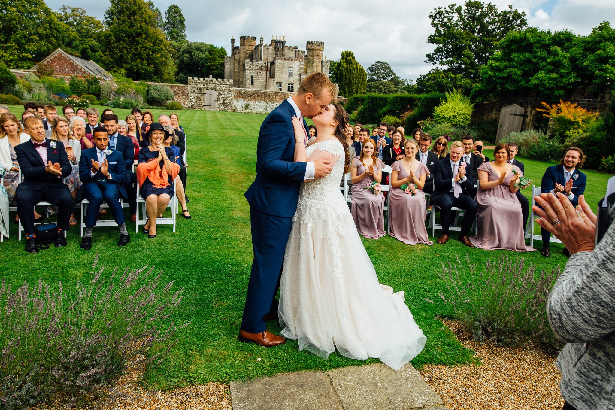  Bride and Groom kiss after being married in the walled garden at Wadhurst Castle 