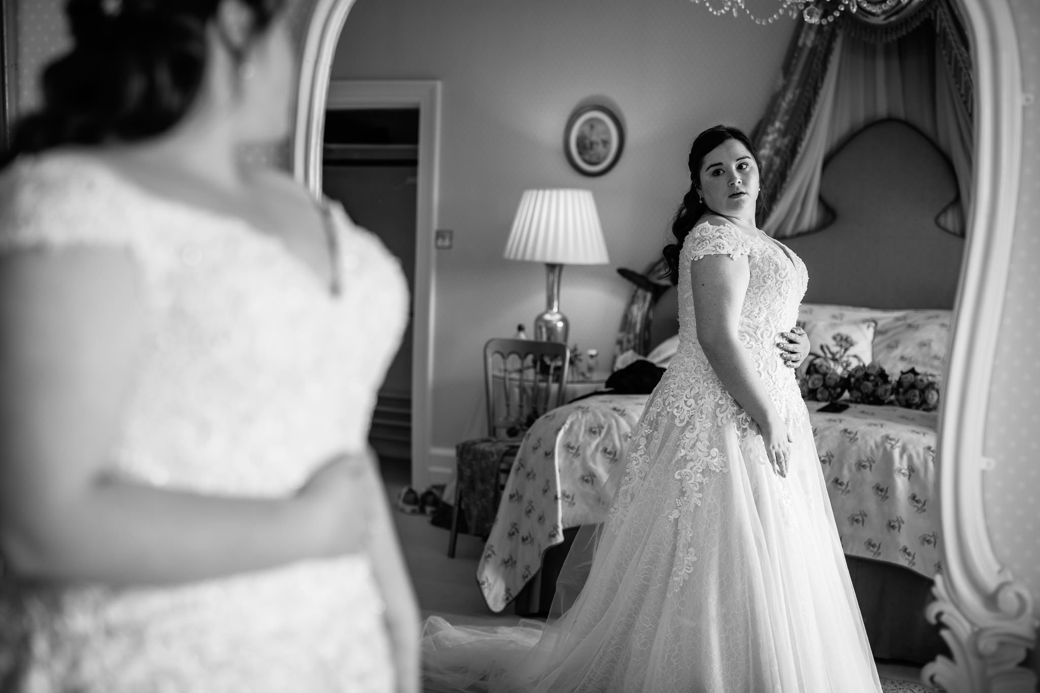  Bride looking at her reflection before the wedding ceremony at Wadhurst Castle 