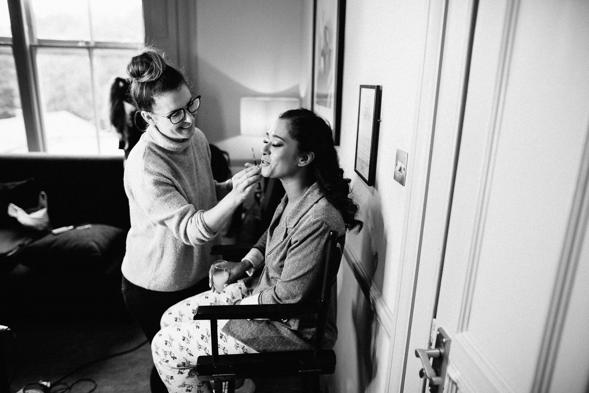  Makeup artist applies makeup to the Bride at Coulsdon Manor Hotel 
