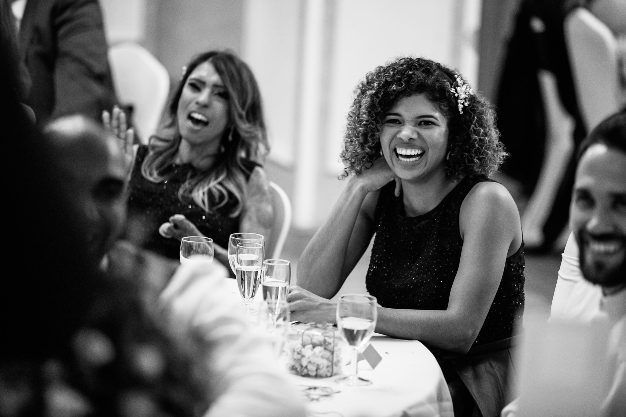  Female wedding guest laughing during the speeches 