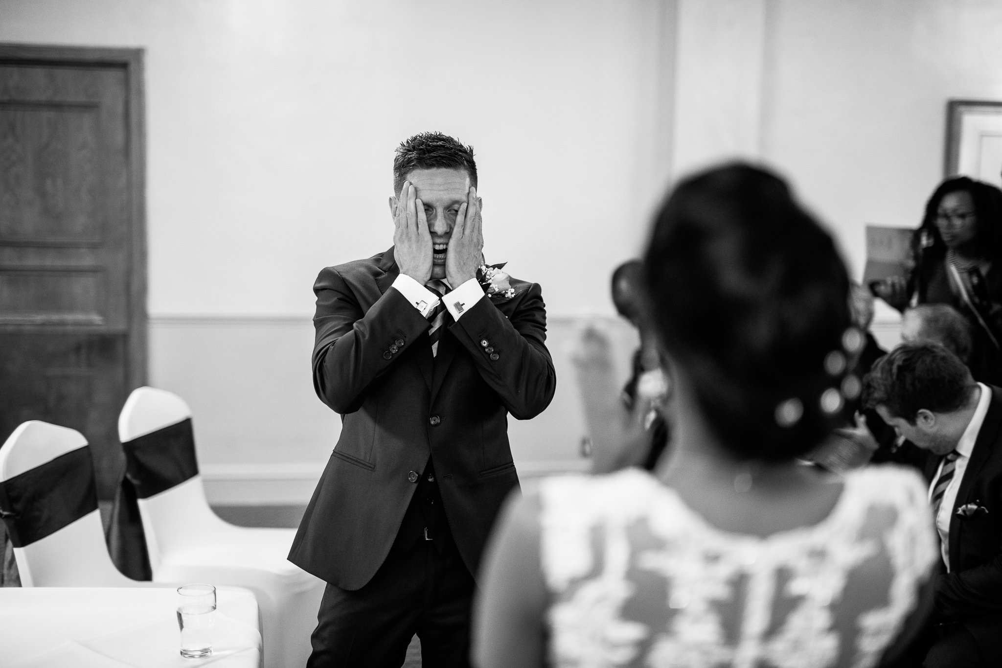  Groom rubbing his face during the ceremony 