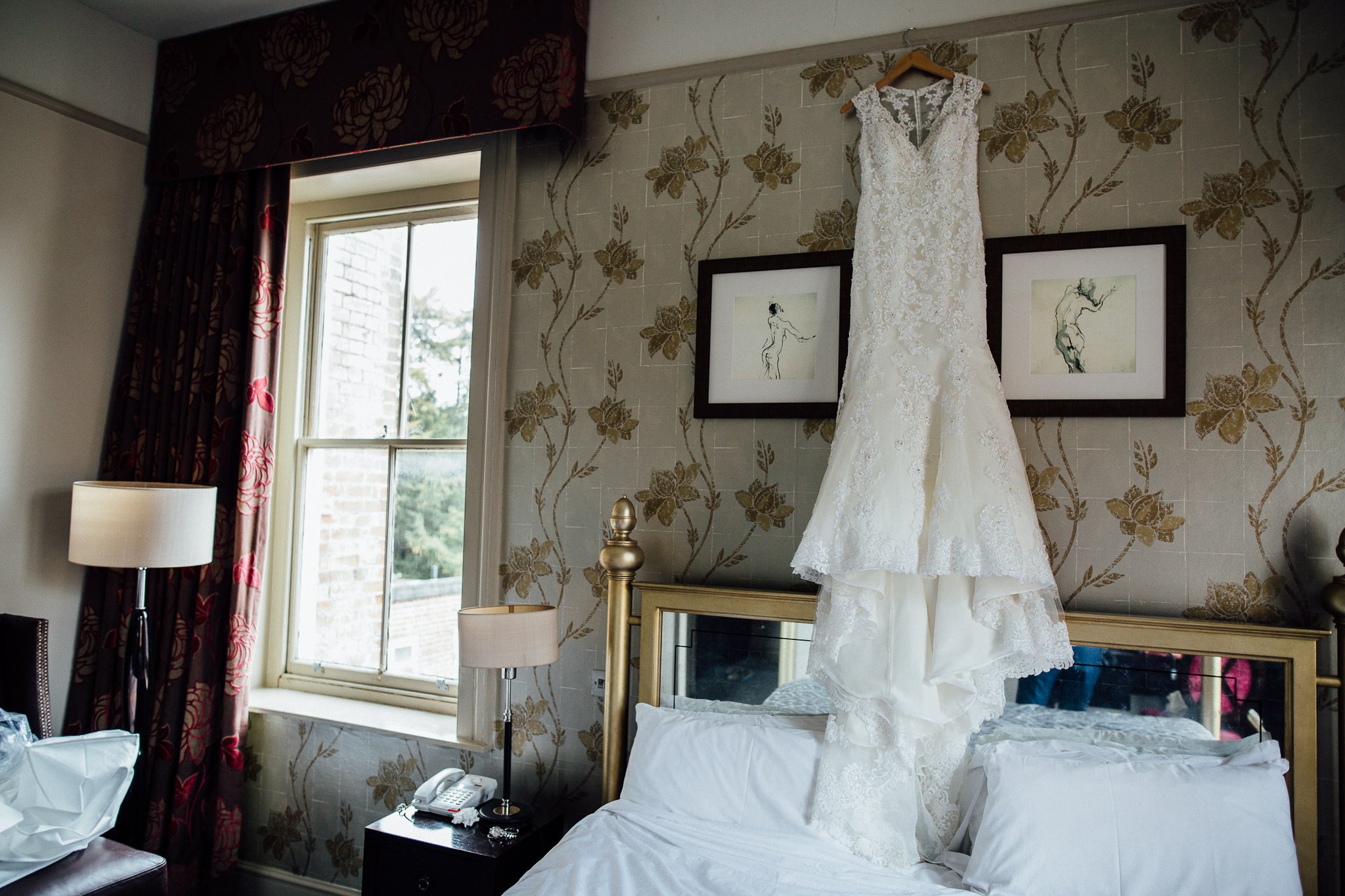  Bride’s wedding dress hanging up at Coulsdon Manor Hotel 