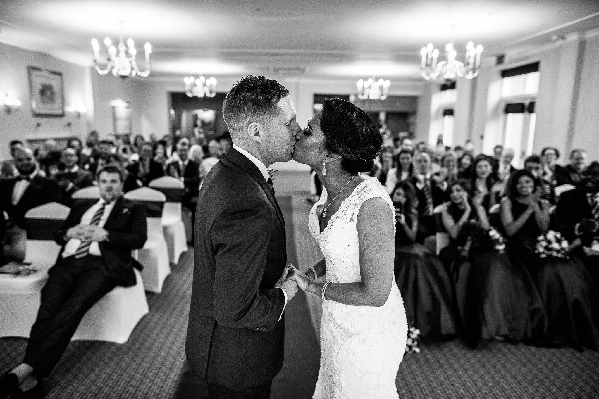  Bride and Groom kiss during their wedding ceremony at Coulsdon Manor Hotel 