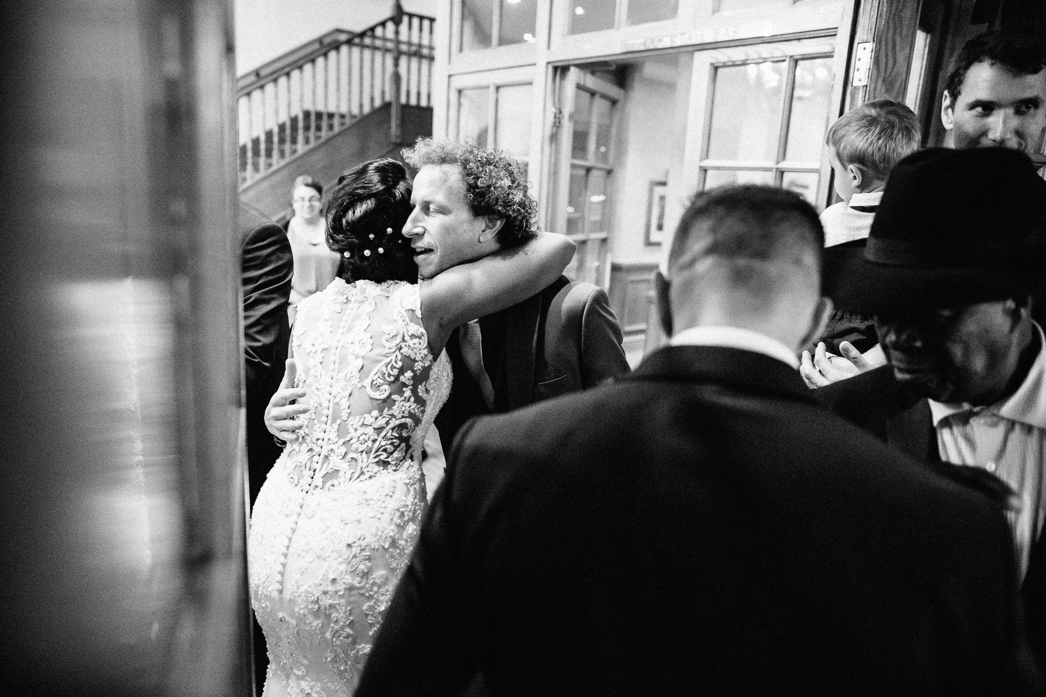  Bride hugs a guest at Coulsdon Manor Hotel 