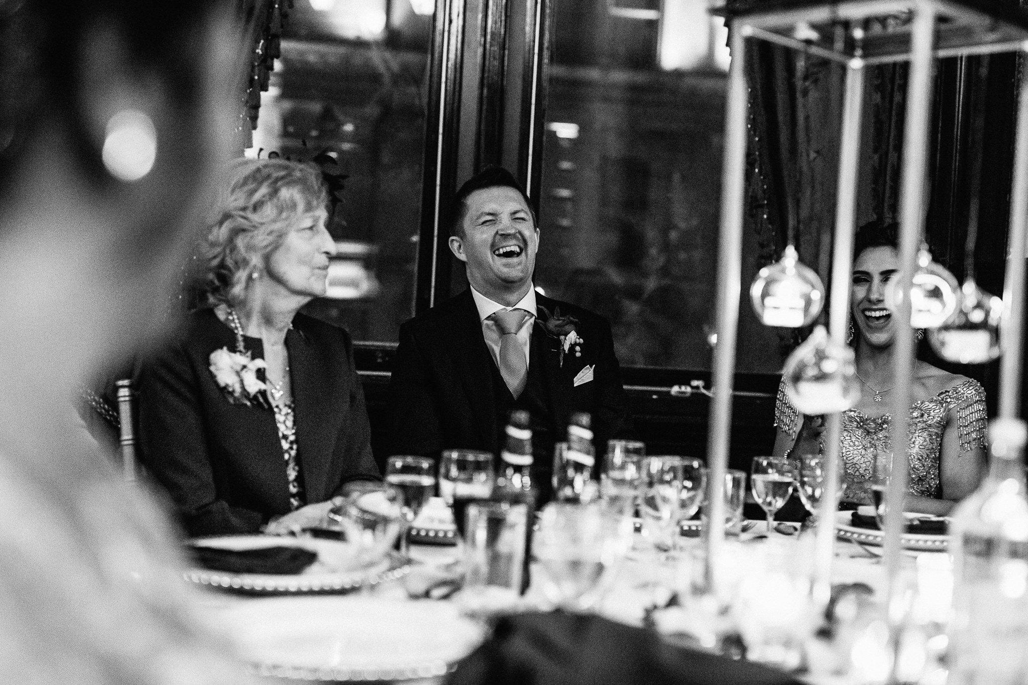  Groom laughing during the speeches at One Whitehall Place 