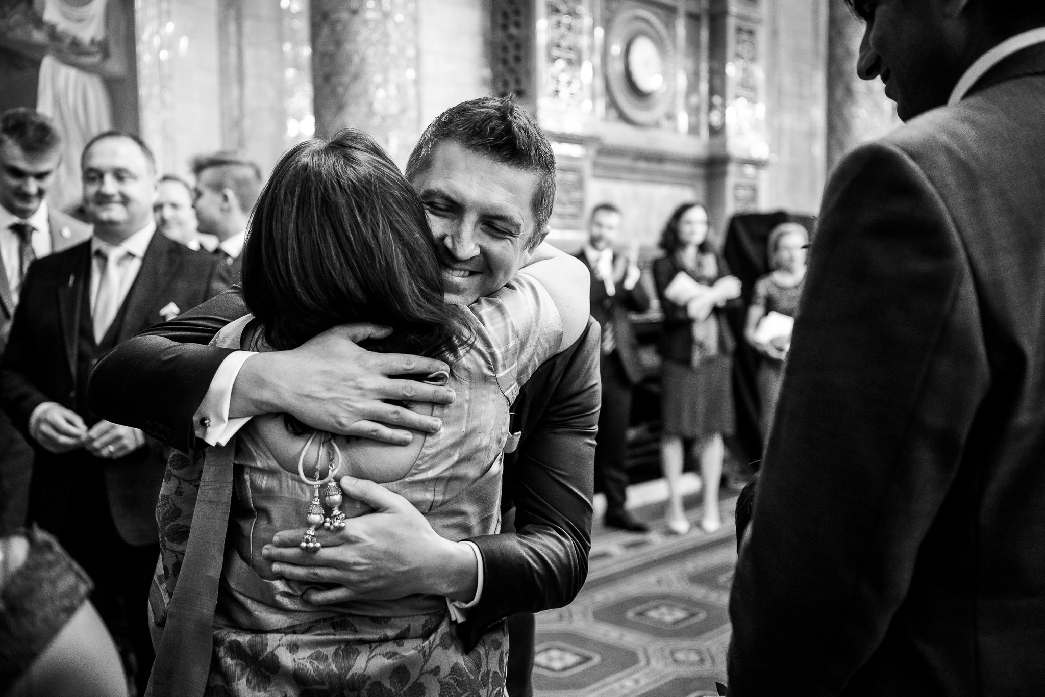  Groom hugging a wedding guest at One Whitehall Place London 