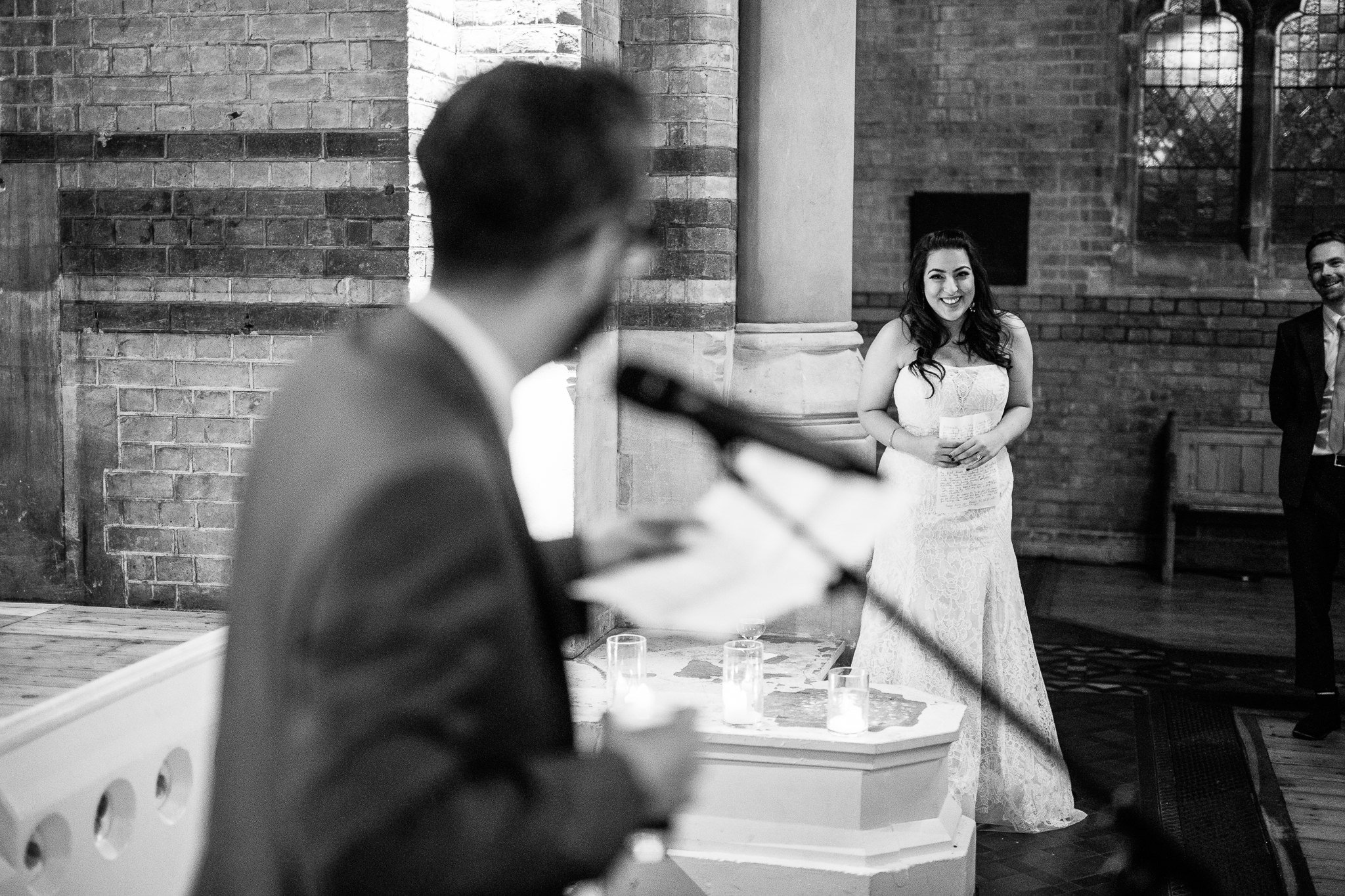  Bride laughing during the speeches on her wedding day at St Stephen’s Trust Hampstead 