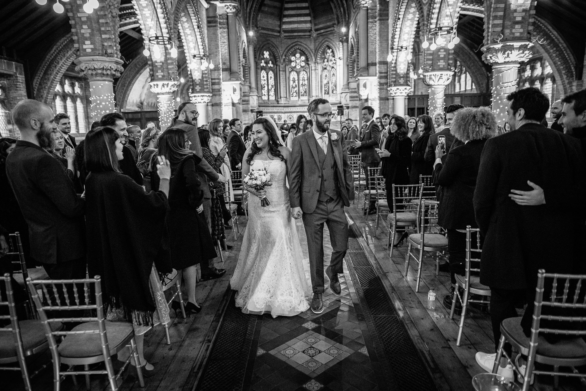  Bride and Groom walk down the aisle after being married at St Stephen’s Trust Hampstead 