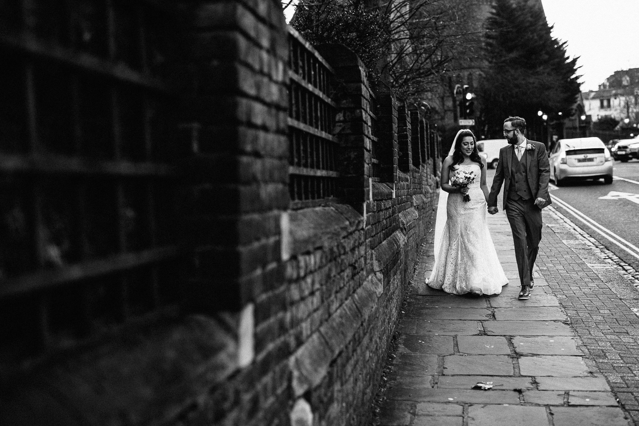  Bride and Groom walking down the road outside St Stephen’s Trust Hampstead London 