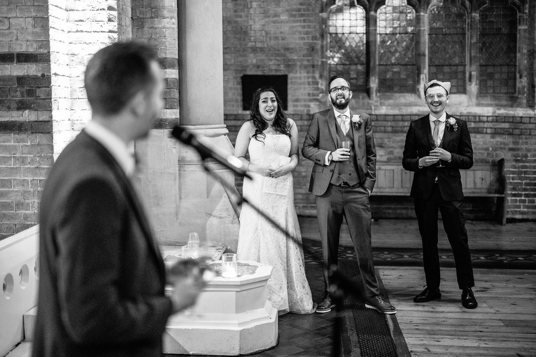  Bride and Groom laughing during the wedding speeches at St Stephen’s Trust Hampstead London 