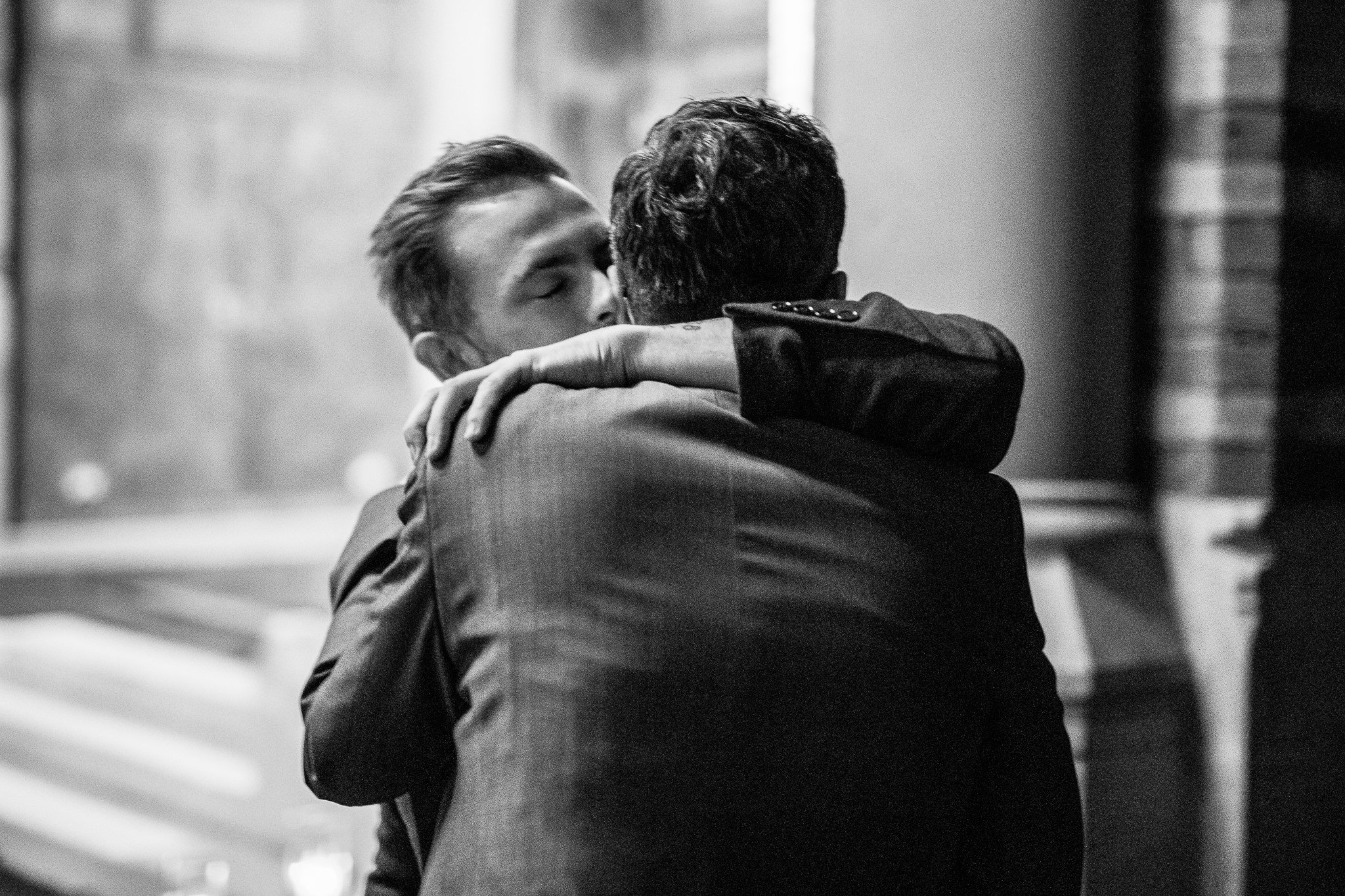  Best man hugs the Groom at St Stephen’s Trust Hampstead London 