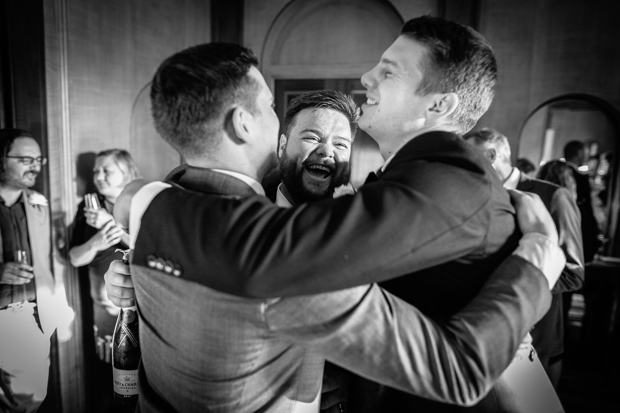  Groom hugs his friends on his wedding day at  Pitzhanger Manor 