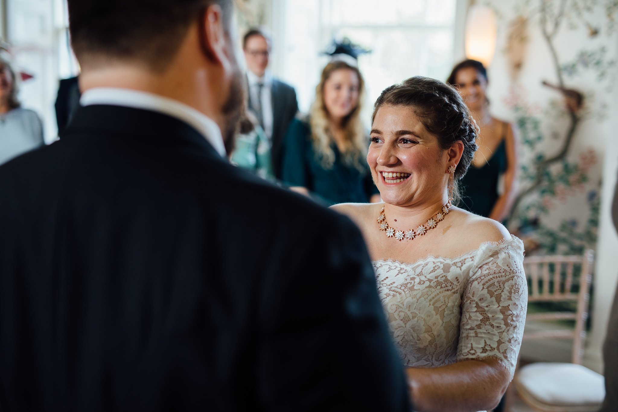  Bride smiling during the wedding ceremony at  Pitzhanger Manor 