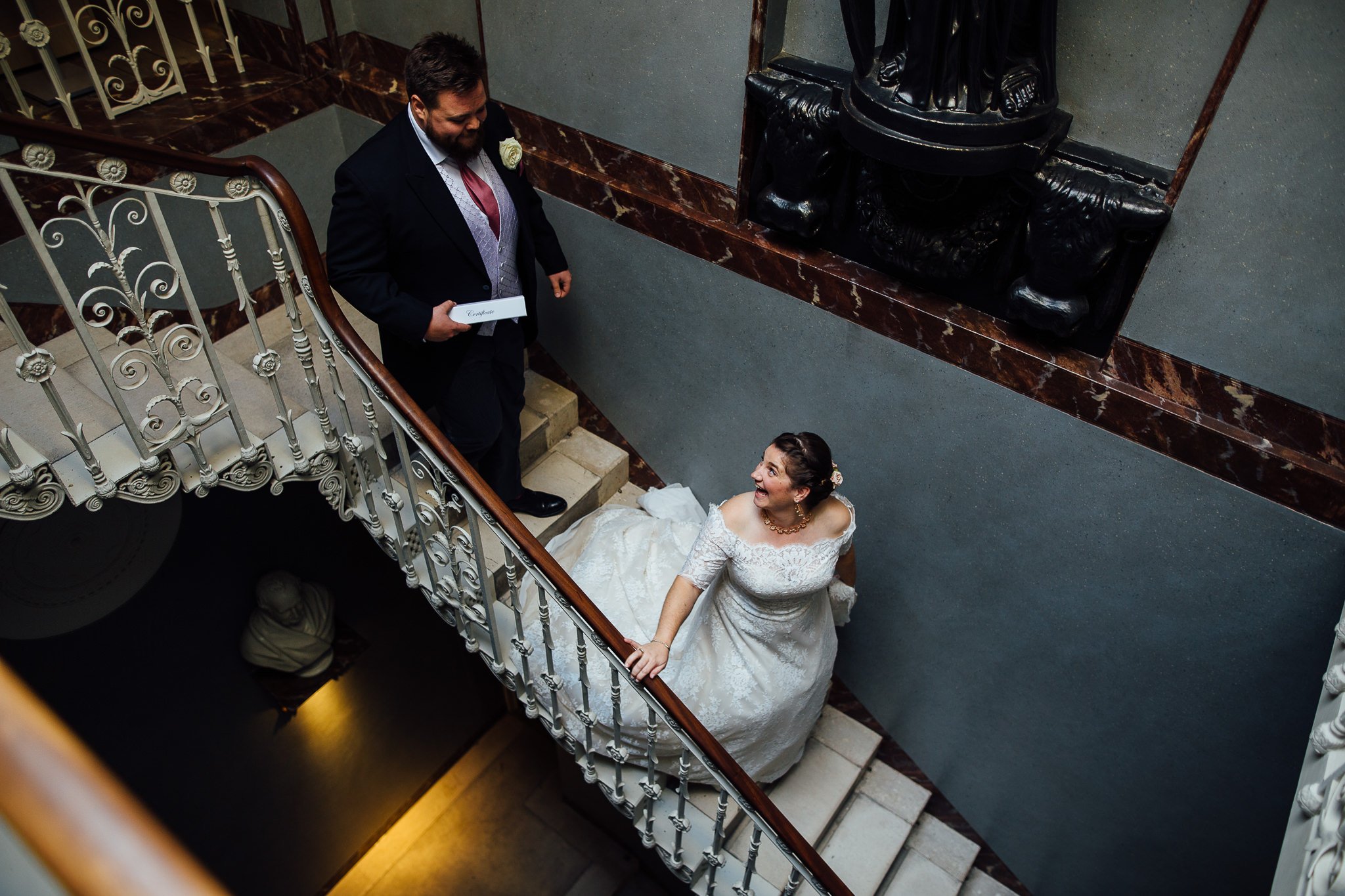  Bride and Groom descend the staircase after being married at  Pitzhanger Manor 