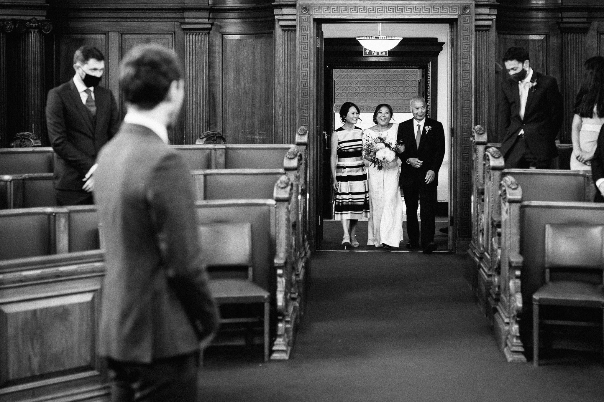 Bride walks into the council chamber at Islington Town Hall 
